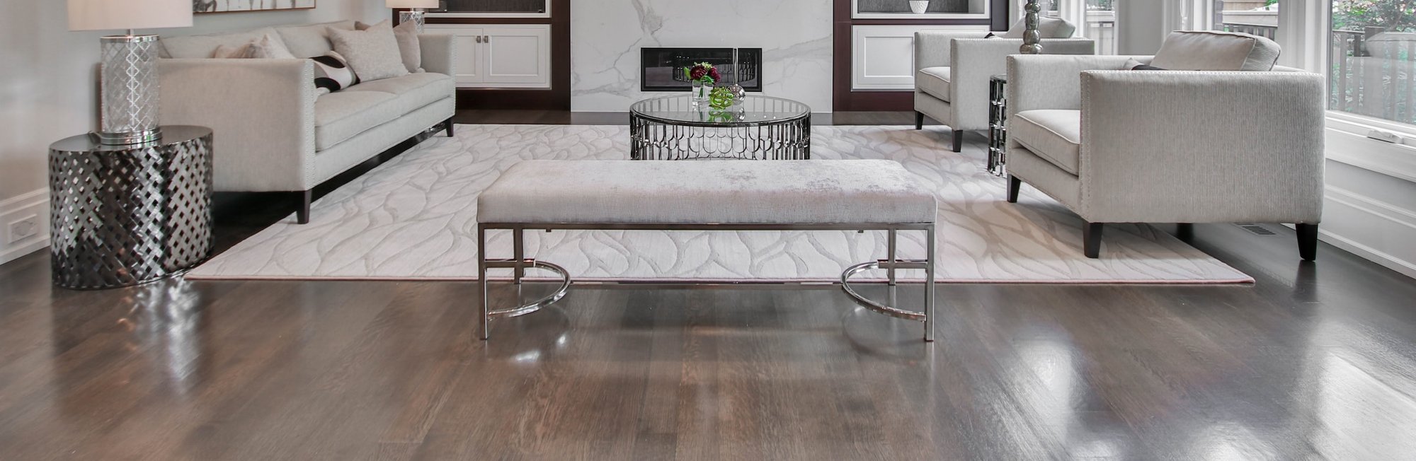 Modern white washed room with hardwood floors and rug